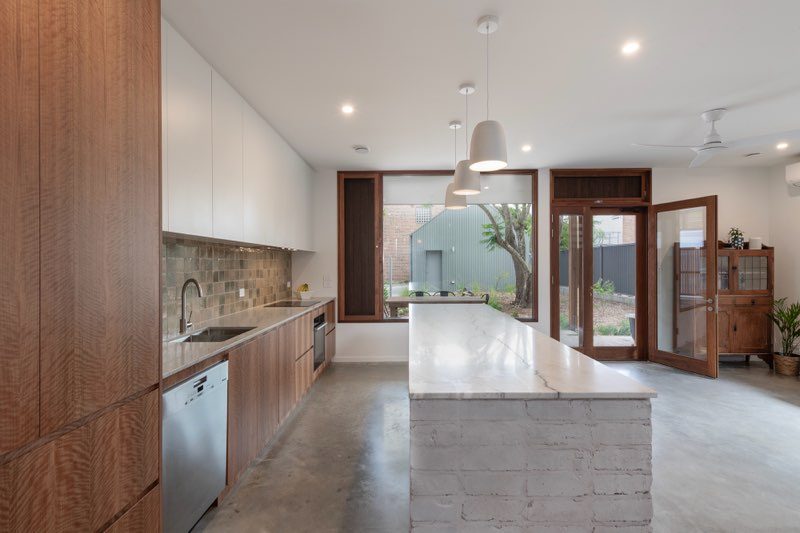 Modern kitchen with timber cabinetry, marble island and white joinery