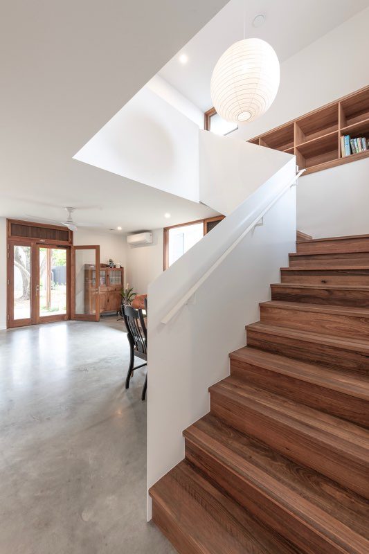 Timber staircase beside an open dining area